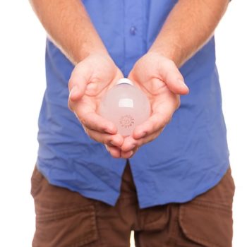 Man holding a lightbulb in both hands