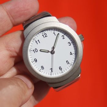 Man holding an analogue silver wristwatch