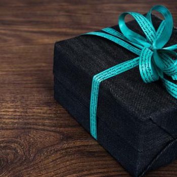 Wrapped gift box with a turquoise bow