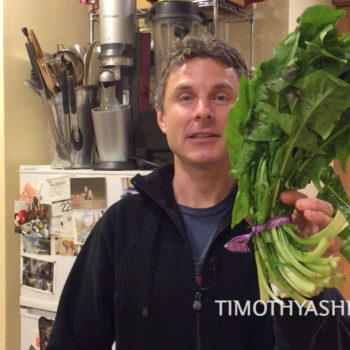 Tim holding dandelion greens