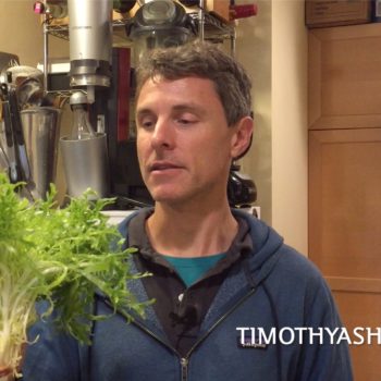 Tim holding bitter salad greens