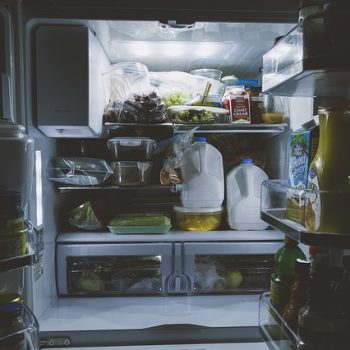 refrigerator doors open in a dark room